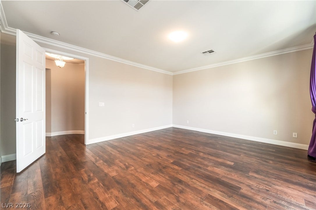 11416 Rancho Portena Avenue, Las Vegas, NV 89138 Polished hardwood flooring and detailed crown molding enhance this versatile bedroom space.