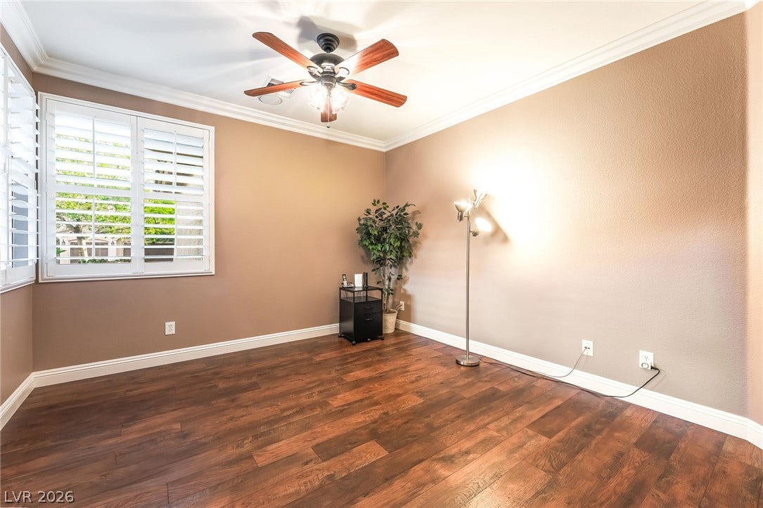 11416 Rancho Portena Avenue, Las Vegas, NV 89138 Rich wood-inspired floors and classic crown molding define this versatile living space.