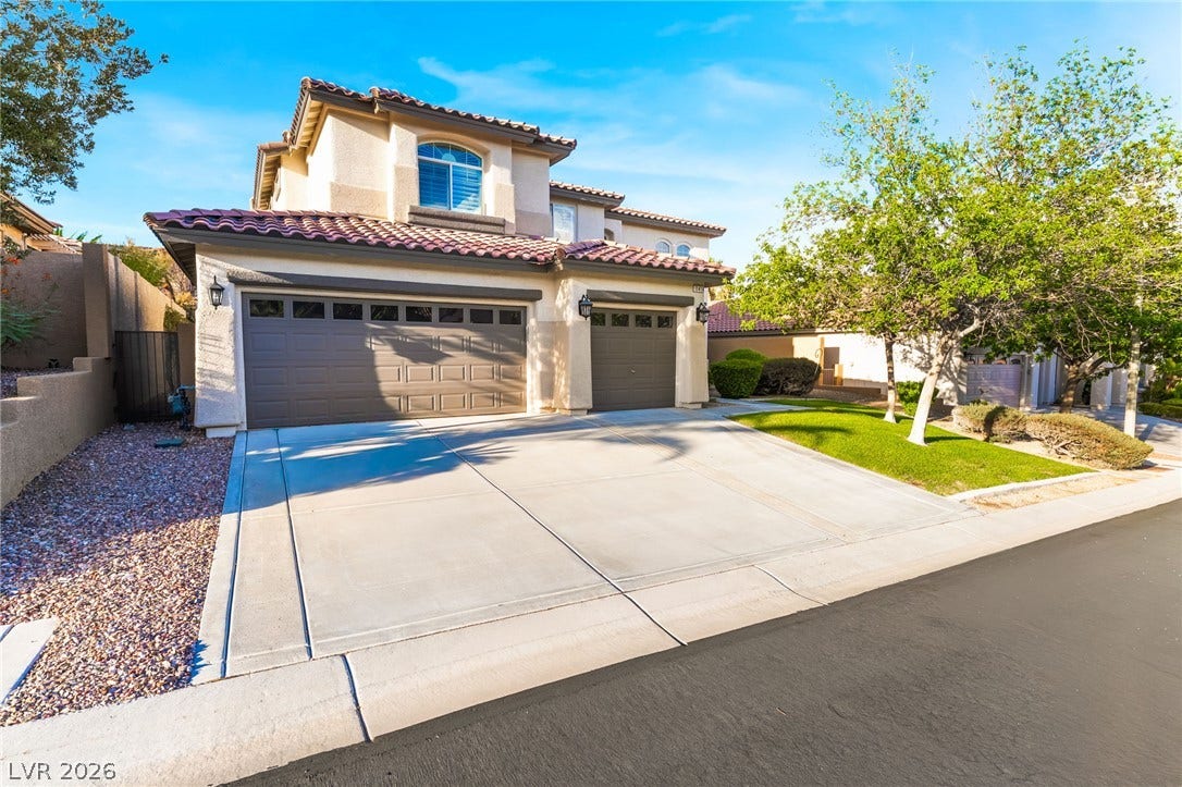 11416 Rancho Portena Avenue, Las Vegas, NV 89138 A spacious driveway leads to this classic multi-level residence under a barrel tile roof.