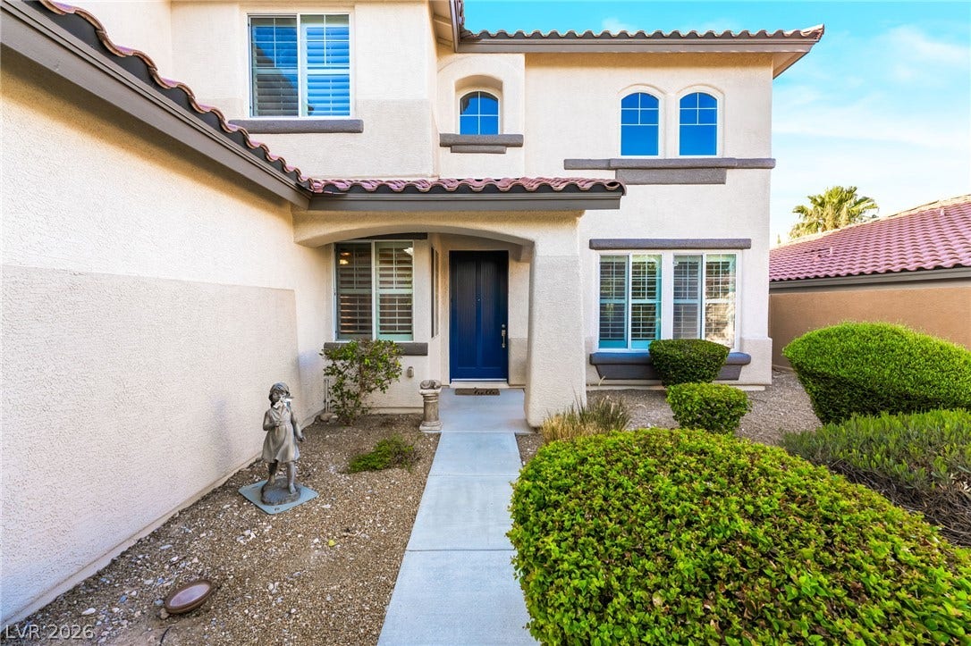 11416 Rancho Portena Avenue, Las Vegas, NV 89138 An inviting concrete walkway leads to the classic covered front entry of this two-story stucco home.