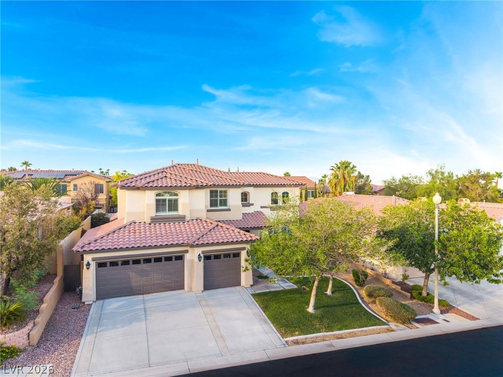 11416 Rancho Portena Avenue, Las Vegas, NV 89138 A spacious driveway and multi-car garage front this handsome two-story stucco home.