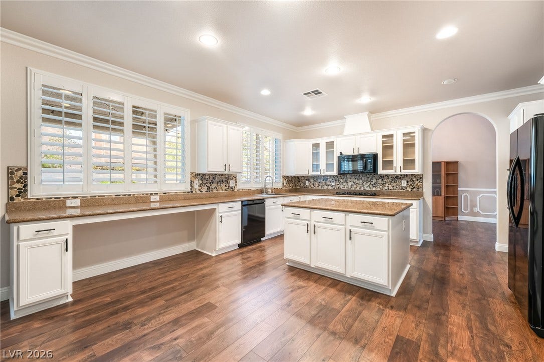 11416 Rancho Portena Avenue, Las Vegas, NV 89138 Gleaming hardwood floors and a spacious central island anchor this modern open kitchen design.