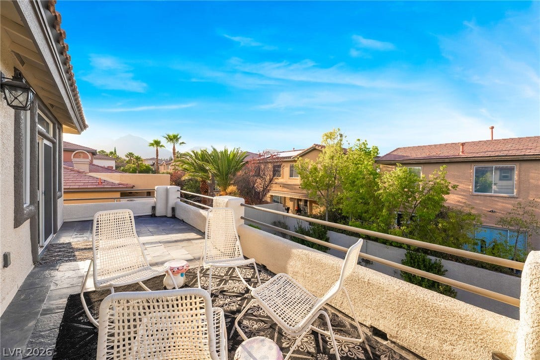 11416 Rancho Portena Avenue, Las Vegas, NV 89138 An elevated terrace provides a private outdoor retreat overlooking neighborhood trees and distant mountain peaks.