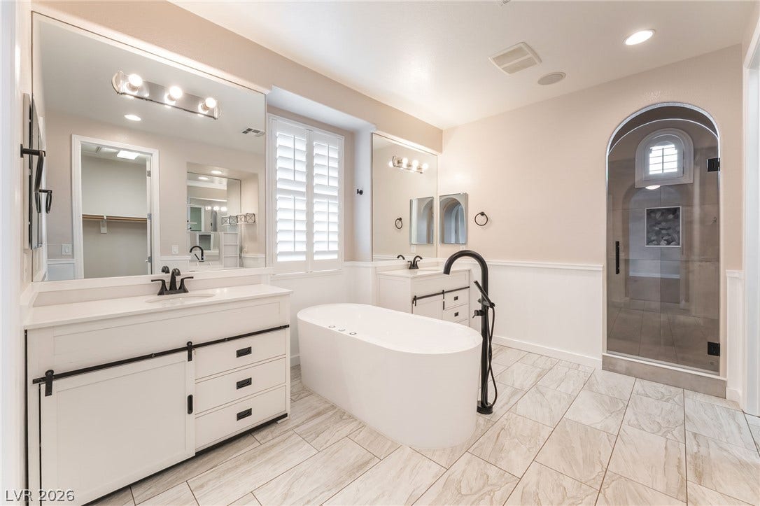 11416 Rancho Portena Avenue, Las Vegas, NV 89138 An elegant freestanding soaking tub anchors this beautifully appointed bathroom featuring tile flooring.
