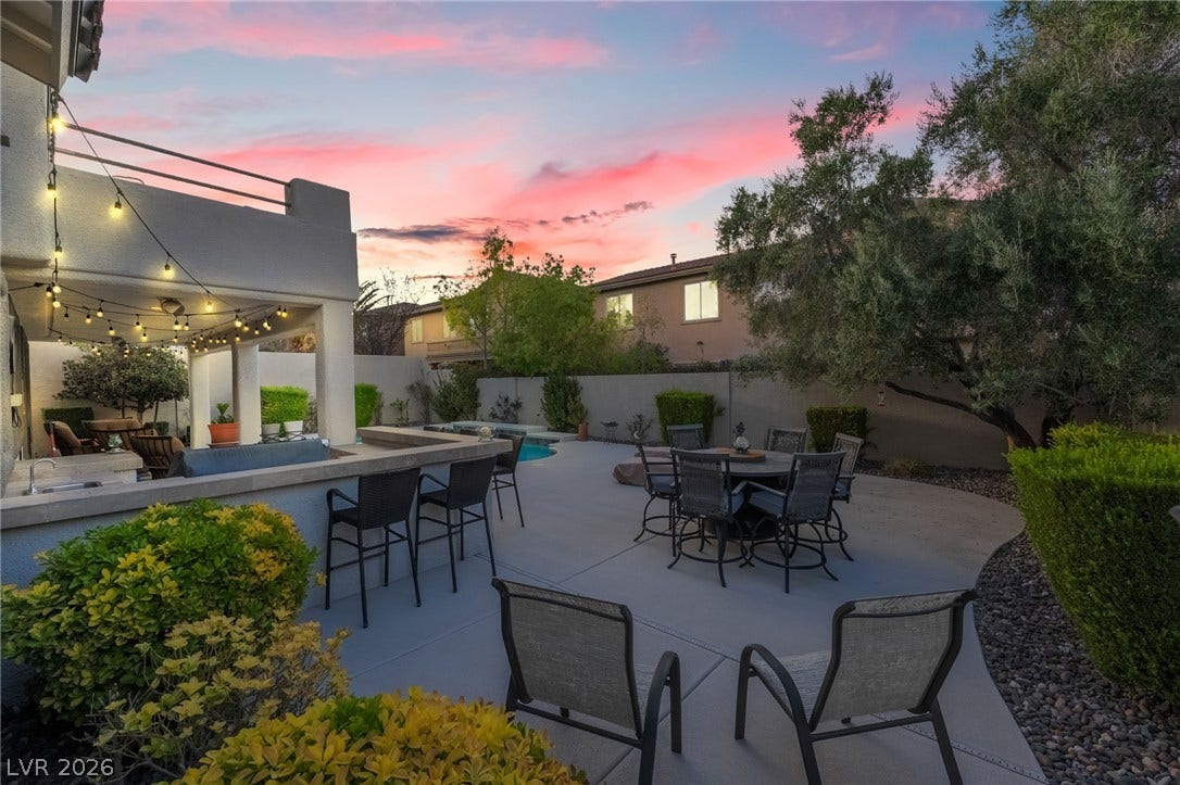 11416 Rancho Portena Avenue, Las Vegas, NV 89138 A spacious concrete patio features an outdoor bar and overlooks a sparkling swimming pool.