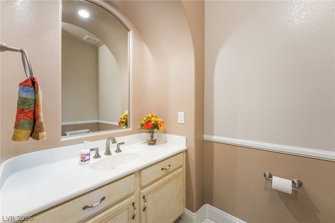 11416 Rancho Portena Avenue, Las Vegas, NV 89138 An elegant arched alcove frames the vanity in this charming half bathroom.