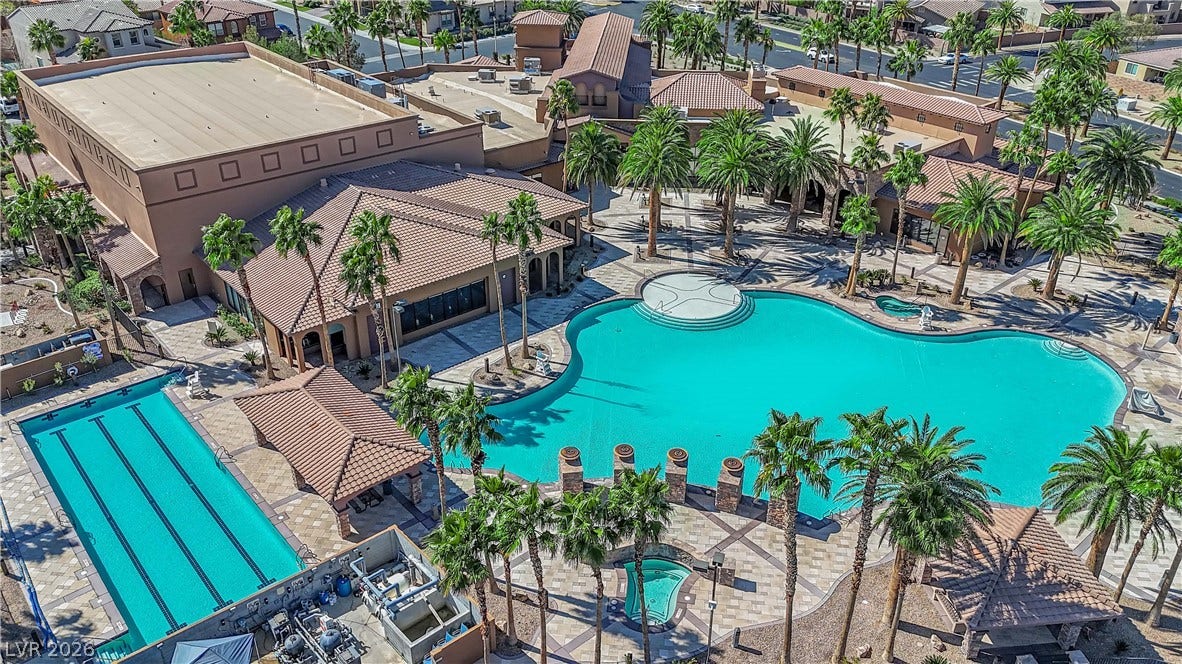 An aerial perspective reveals a vibrant community with multiple sparkling pools and inviting patio areas.