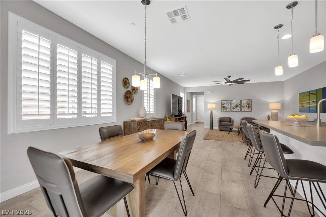 Natural light illuminates this open-concept living space, featuring a seamless flow between dining and relaxation zones.