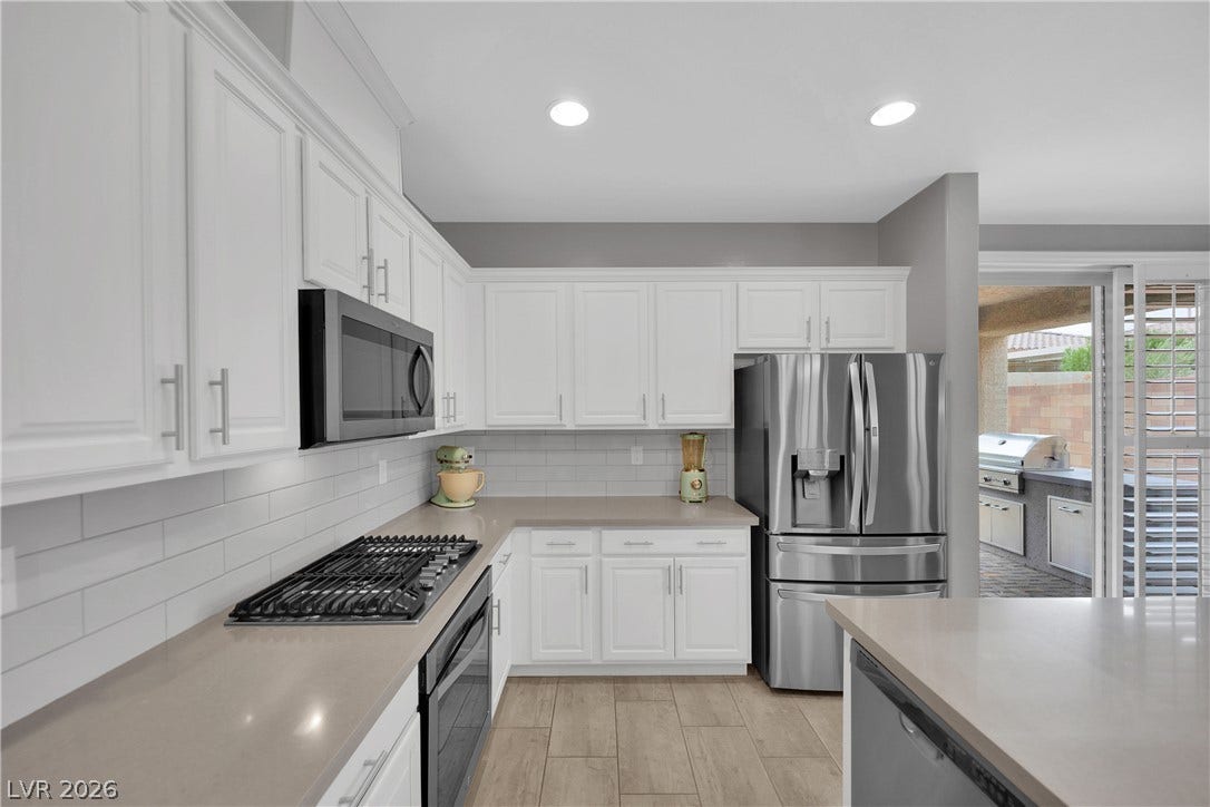 Culinary delights await in this bright kitchen, boasting modern appliances and seamless indoor-outdoor entertaining.