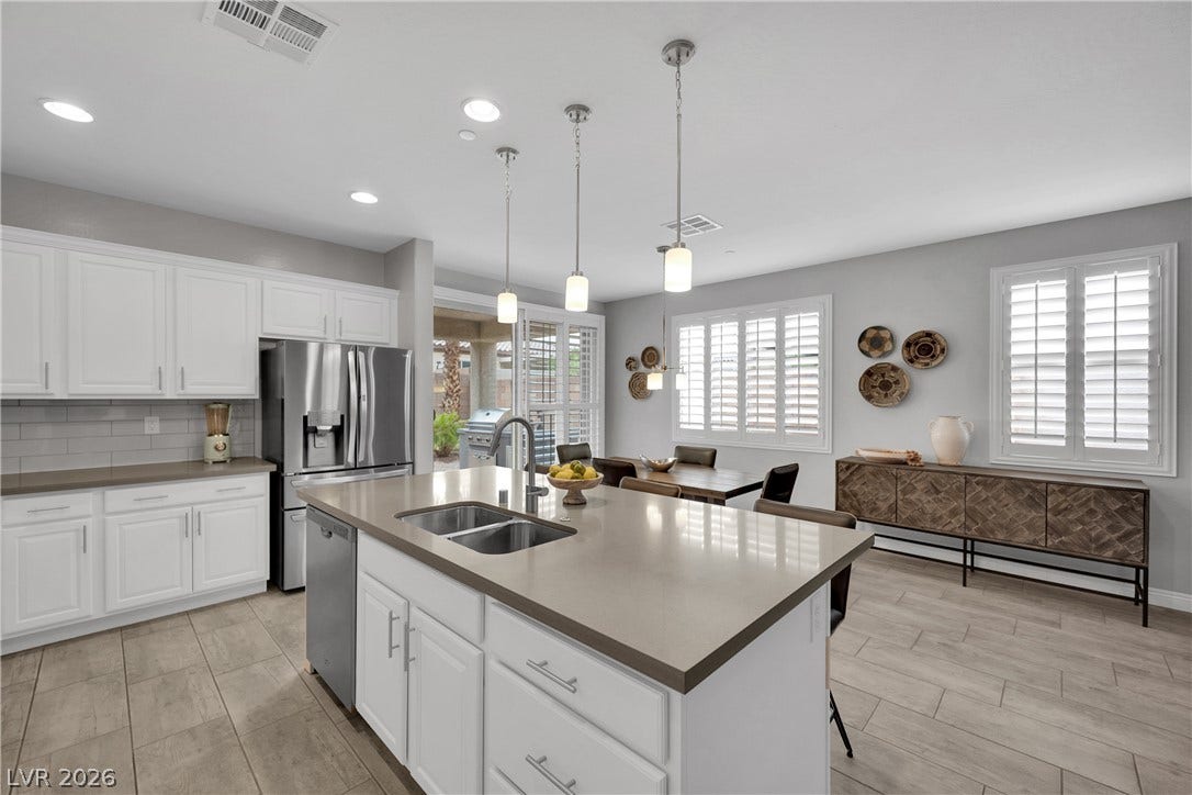 Gleaming counters and modern appliances adorn this spacious kitchen, perfect for culinary adventures.