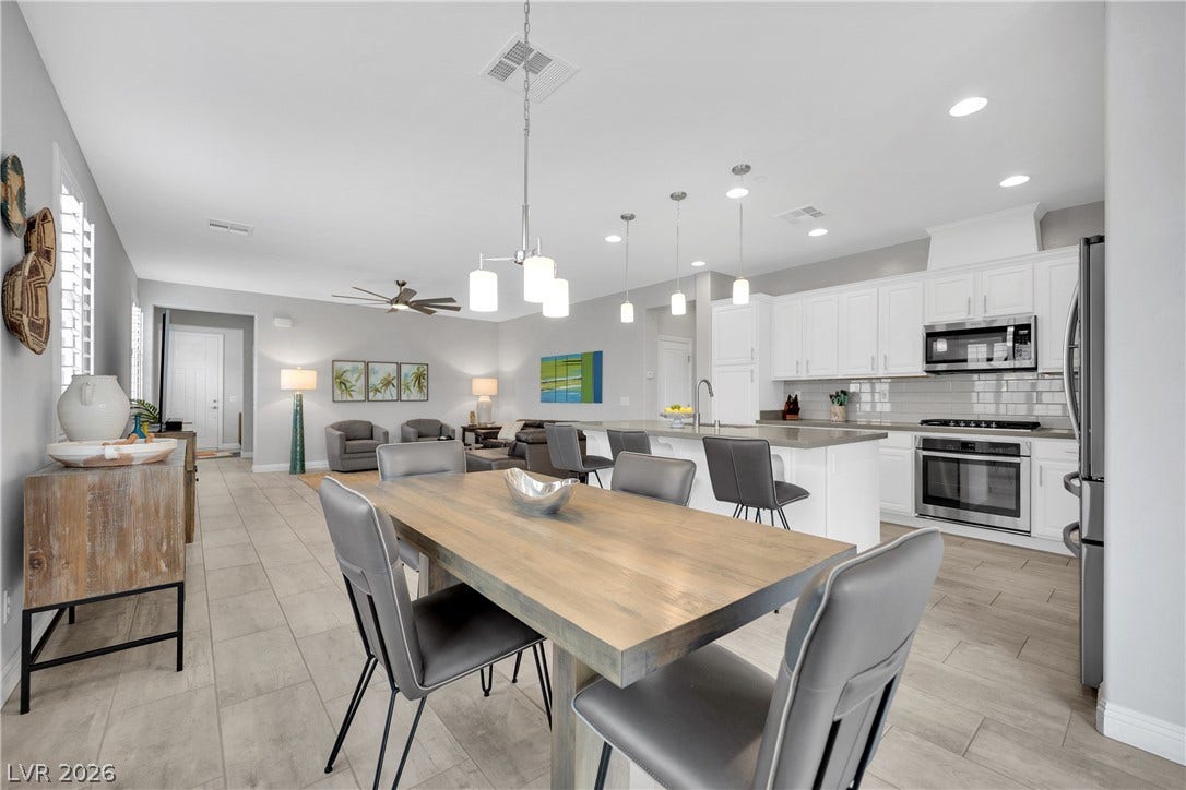 An open-concept living space with a bright kitchen, dining area, and comfortable lounge seating.