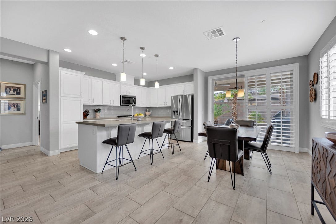 Culinary adventures await in this naturally illuminated kitchen and dining area with seamless indoor-outdoor flow.