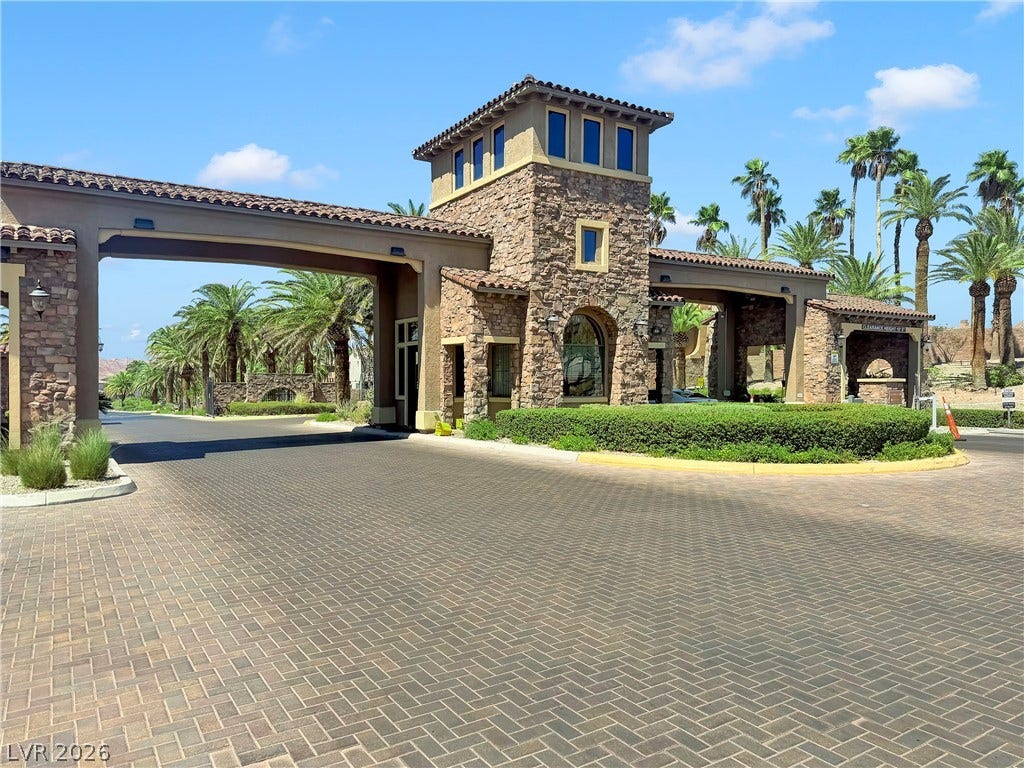 Enter this distinguished community through an impressive stone and stucco gated entry, flanked by lush palm trees.