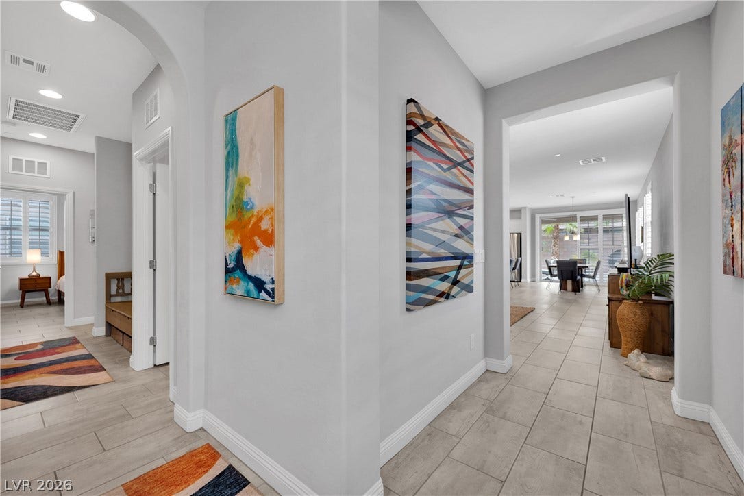 Elegant arched doorways and tiled flooring create a sophisticated, flowing interior.