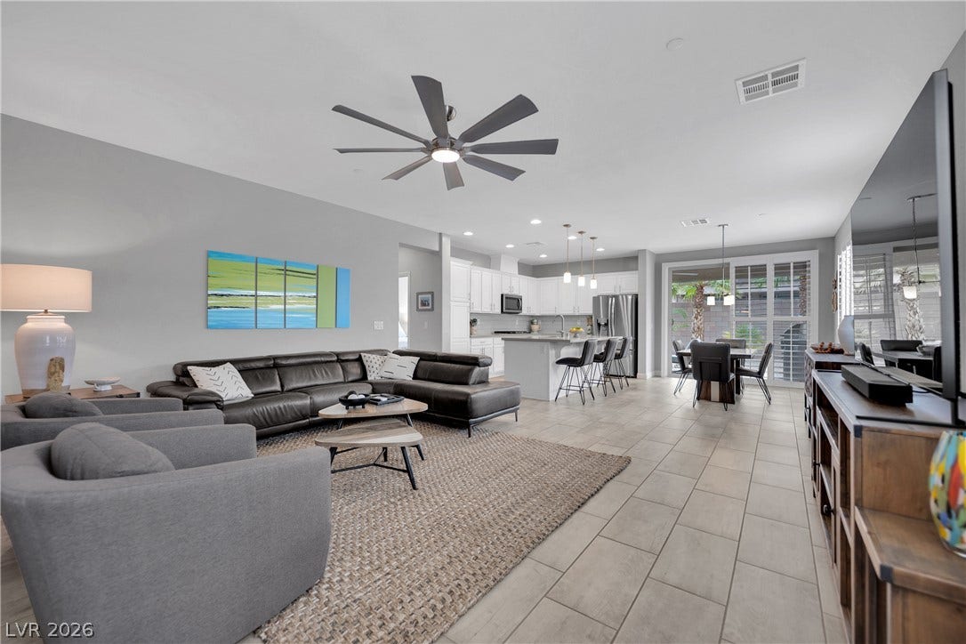 An open-concept living area flows seamlessly into the kitchen and dining space, perfect for entertaining.