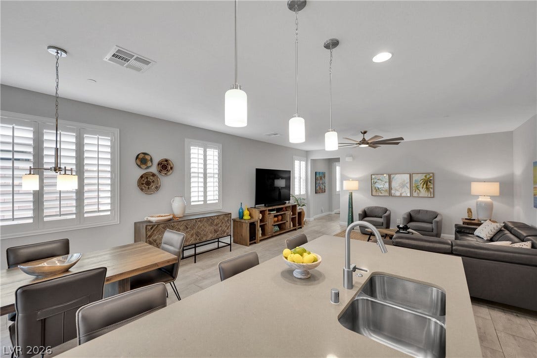 An open-concept living space with a contemporary kitchen island and elegant dining area.
