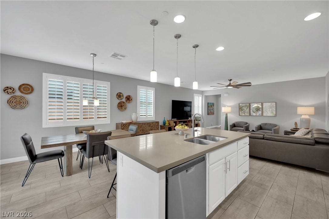 An inviting open-concept layout connects the kitchen, dining, and living areas, offering effortless flow.