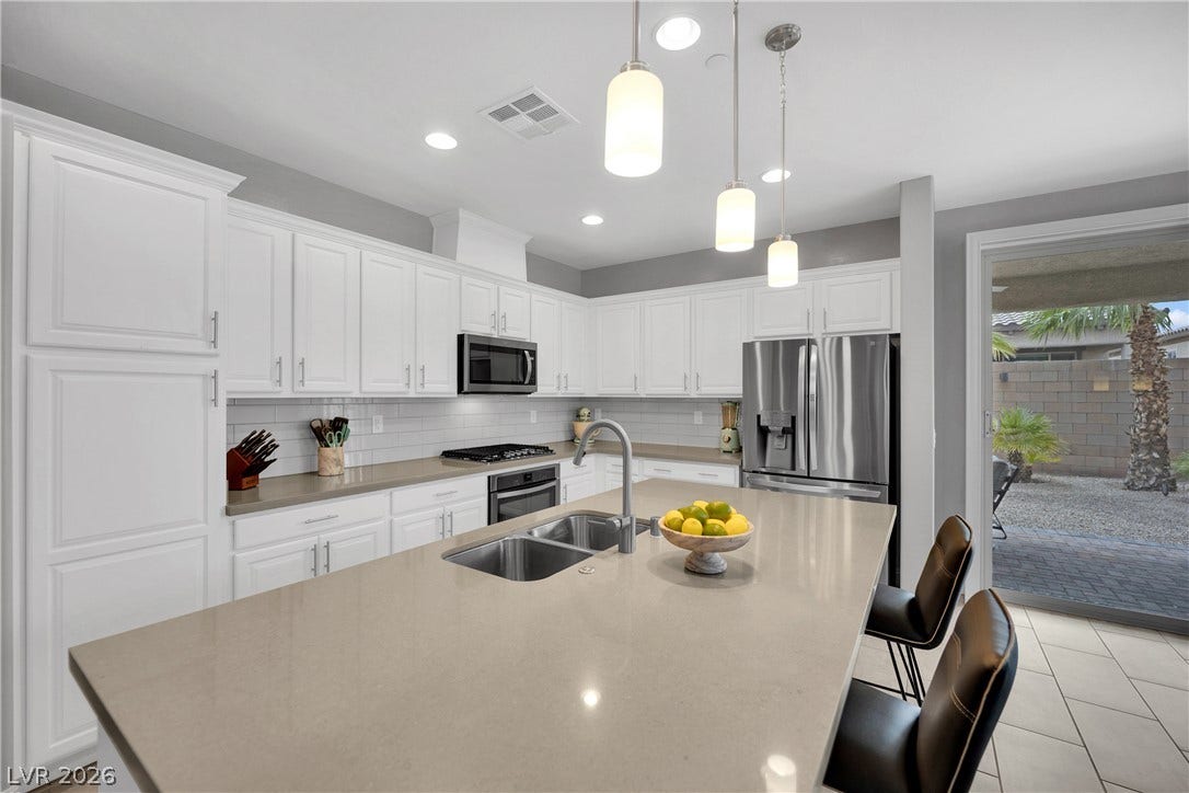 Culinary delights await in this modern kitchen with ample counter space and sleek appliances.