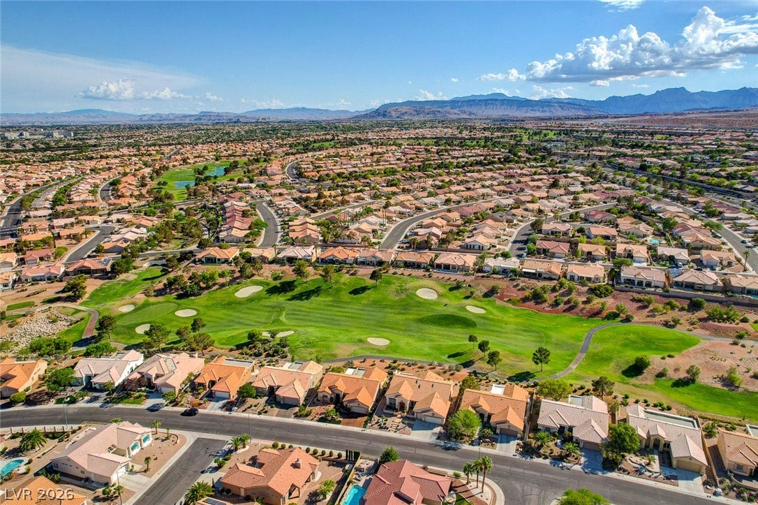 2621 Hanging Rock Drive, Las Vegas, NV 89134 A scenic neighborhood landscape borders a verdant golf course against a distant mountain backdrop.