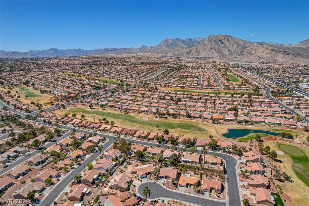 2621 Hanging Rock Drive, Las Vegas, NV 89134 Dramatic mountain peaks frame an expansive master-planned neighborhood bisected by a green golf course.