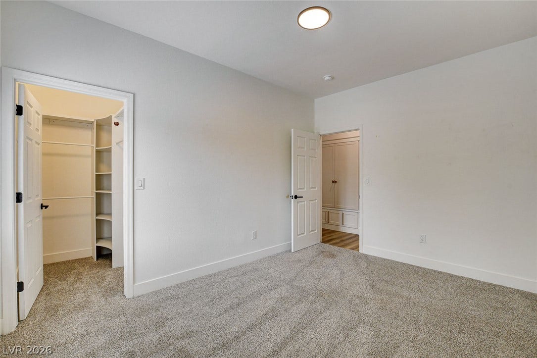 2621 Hanging Rock Drive, Las Vegas, NV 89134 Plush carpeting and a spacious walk-in closet define this comfortable bedroom space.
