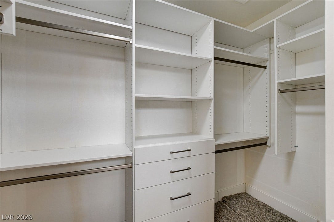 2621 Hanging Rock Drive, Las Vegas, NV 89134 Custom built-in shelving and soft carpeting define this organized closet space.