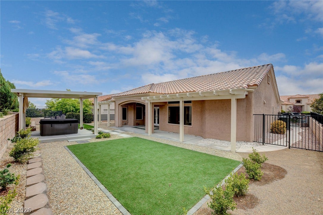 2621 Hanging Rock Drive, Las Vegas, NV 89134 An inviting backyard setting features a covered patio and low-maintenance turf lawn.