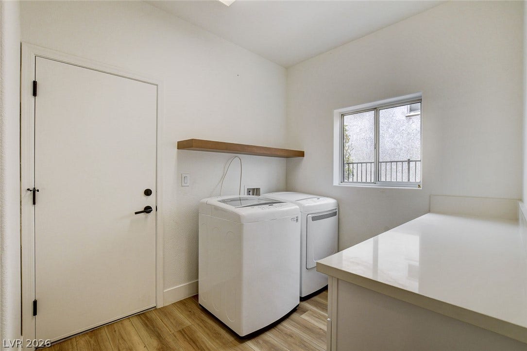 2621 Hanging Rock Drive, Las Vegas, NV 89134 Streamlined utility area features smooth wood-look flooring and a functional floating shelf.