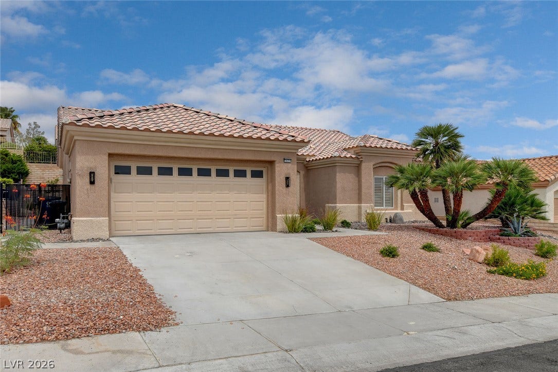 2621 Hanging Rock Drive, Las Vegas, NV 89134 Desert landscaping and a tiled roof enhance the curb appeal of this classic stucco home.