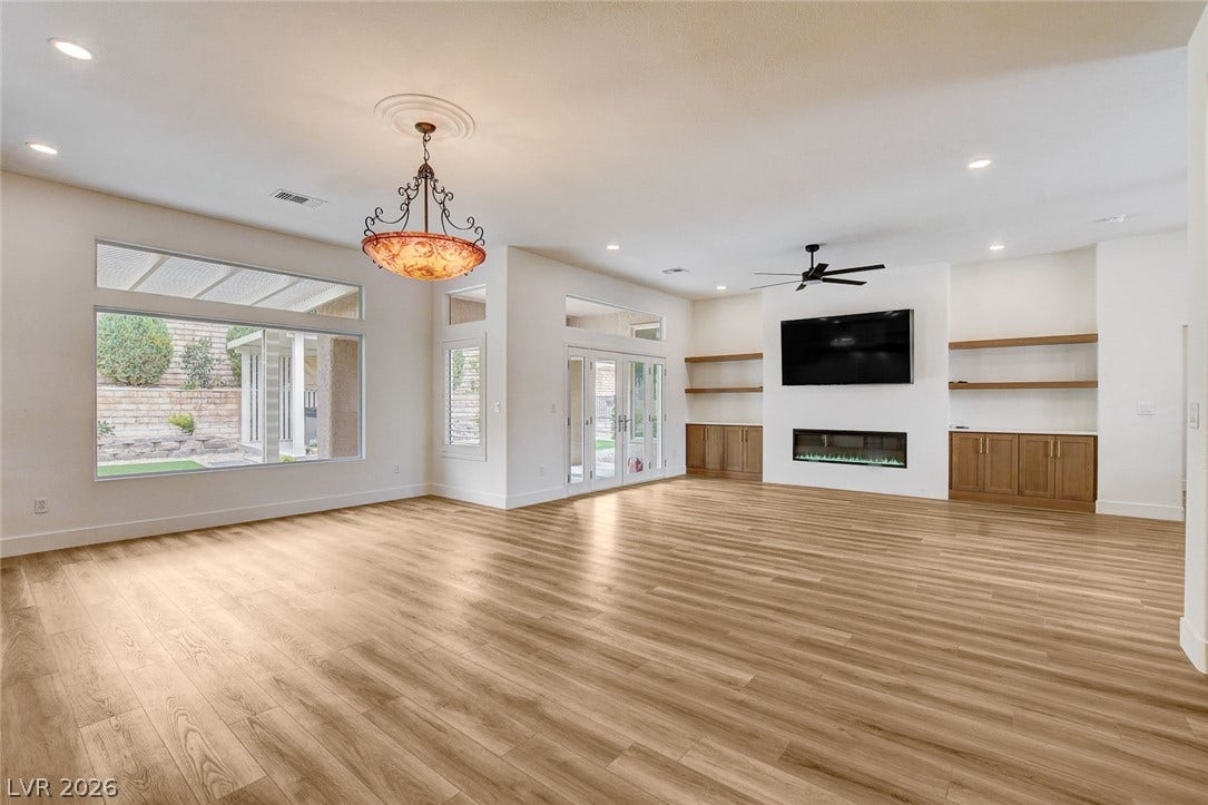 2621 Hanging Rock Drive, Las Vegas, NV 89134 Warm wood flooring stretches across this airy living area accented by custom built-ins.