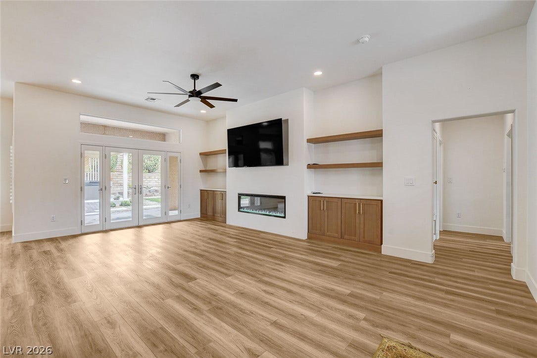 2621 Hanging Rock Drive, Las Vegas, NV 89134 Rich wood flooring runs throughout this spacious living area complete with integrated custom built-ins.