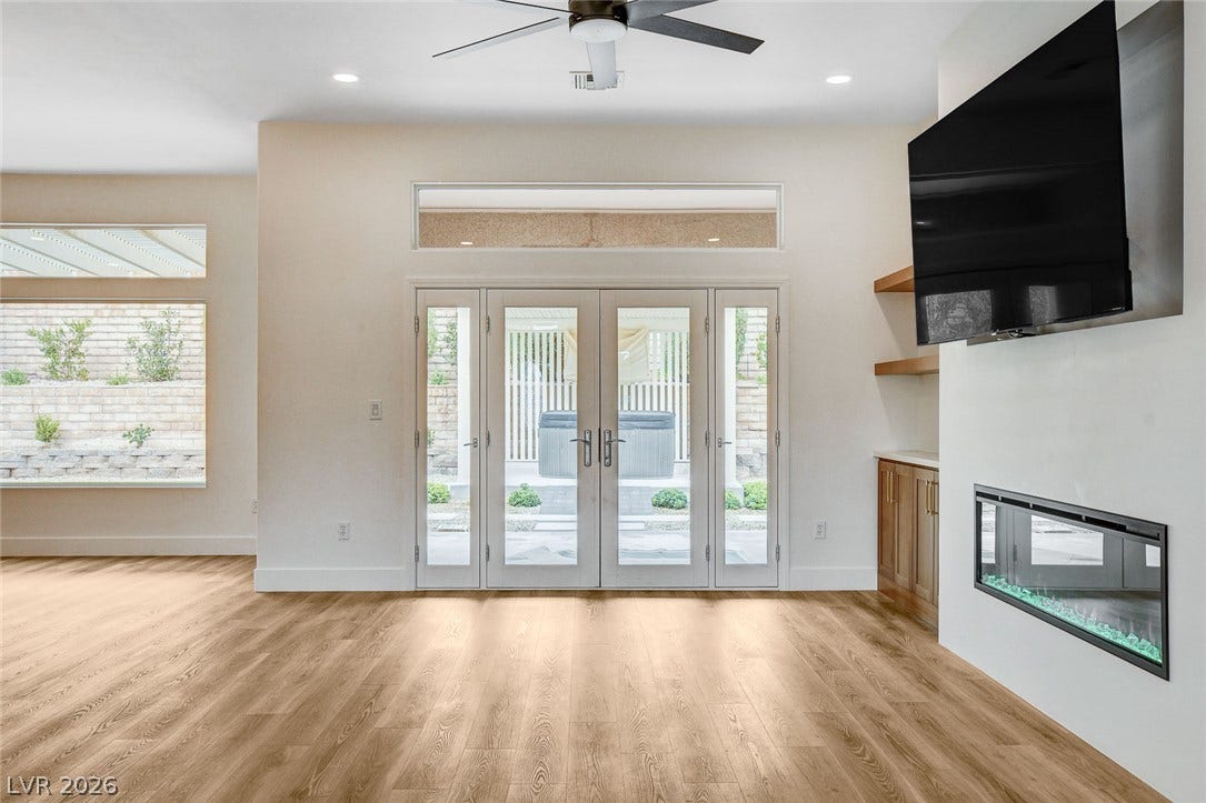 2621 Hanging Rock Drive, Las Vegas, NV 89134 Warm wood flooring and a modern fireplace define this open living area.