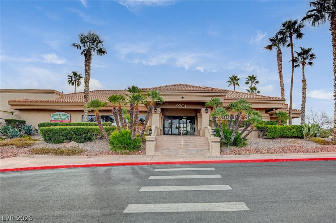 2621 Hanging Rock Drive, Las Vegas, NV 89134 Palm trees frame the entrance of this tiled-roof stucco clubhouse.