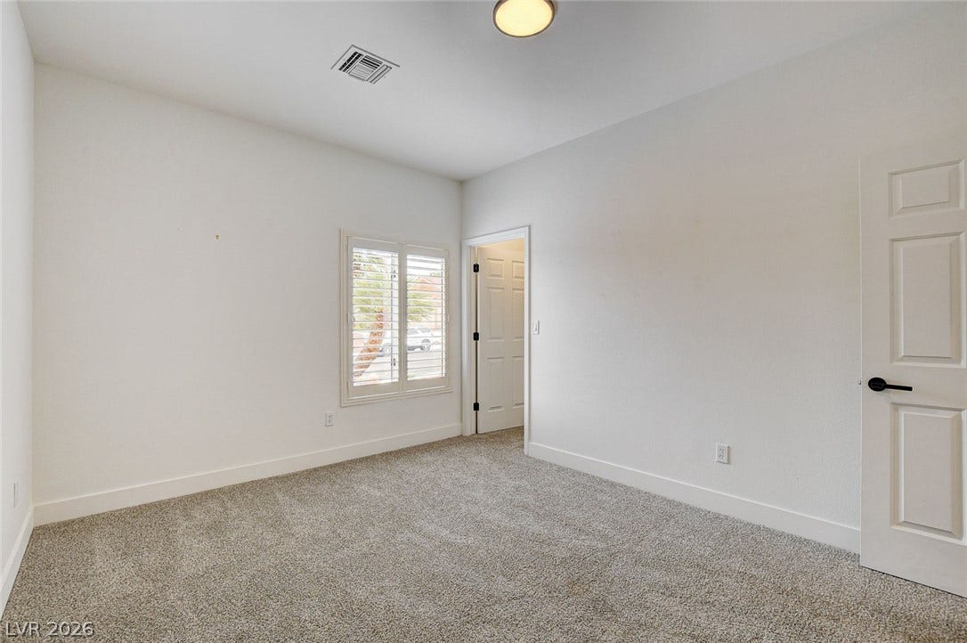 2621 Hanging Rock Drive, Las Vegas, NV 89134 Plush carpeting and classic plantation shutters define this versatile, light-filled interior space.