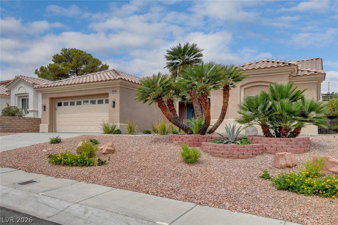 2621 Hanging Rock Drive, Las Vegas, NV 89134 Spanish tile roofing and desert landscaping create classic southwestern curb appeal.