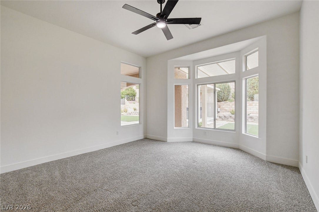 2621 Hanging Rock Drive, Las Vegas, NV 89134 A spacious bay window bathes this carpeted room in natural light.