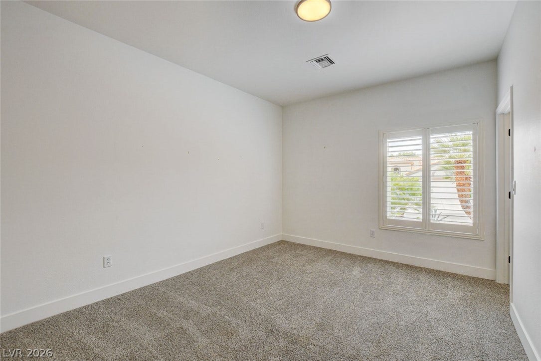 2621 Hanging Rock Drive, Las Vegas, NV 89134 Plush carpeting and plantation shutters define this versatile secondary space.