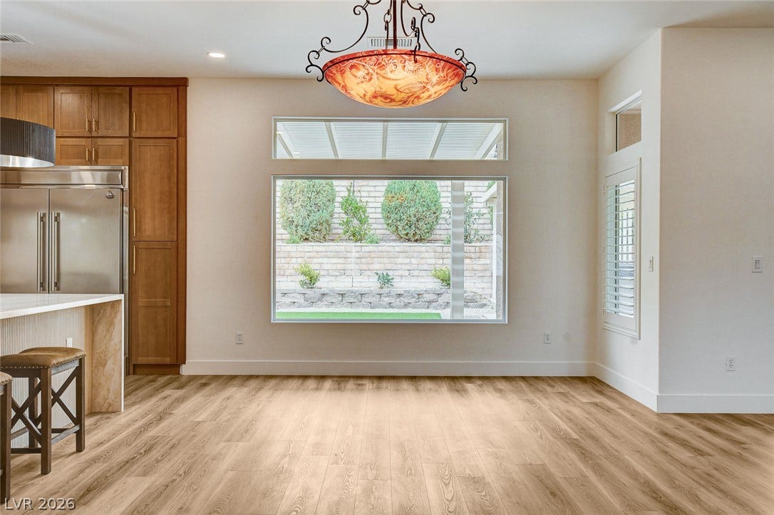 2621 Hanging Rock Drive, Las Vegas, NV 89134 Natural light pours through oversized windows onto handsome wood flooring in this inviting dining area.
