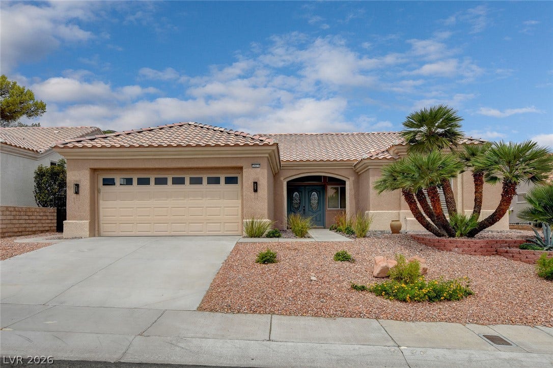 2621 Hanging Rock Drive, Las Vegas, NV 89134 Spanish tile roofing and desert landscaping create classic southwestern curb appeal.