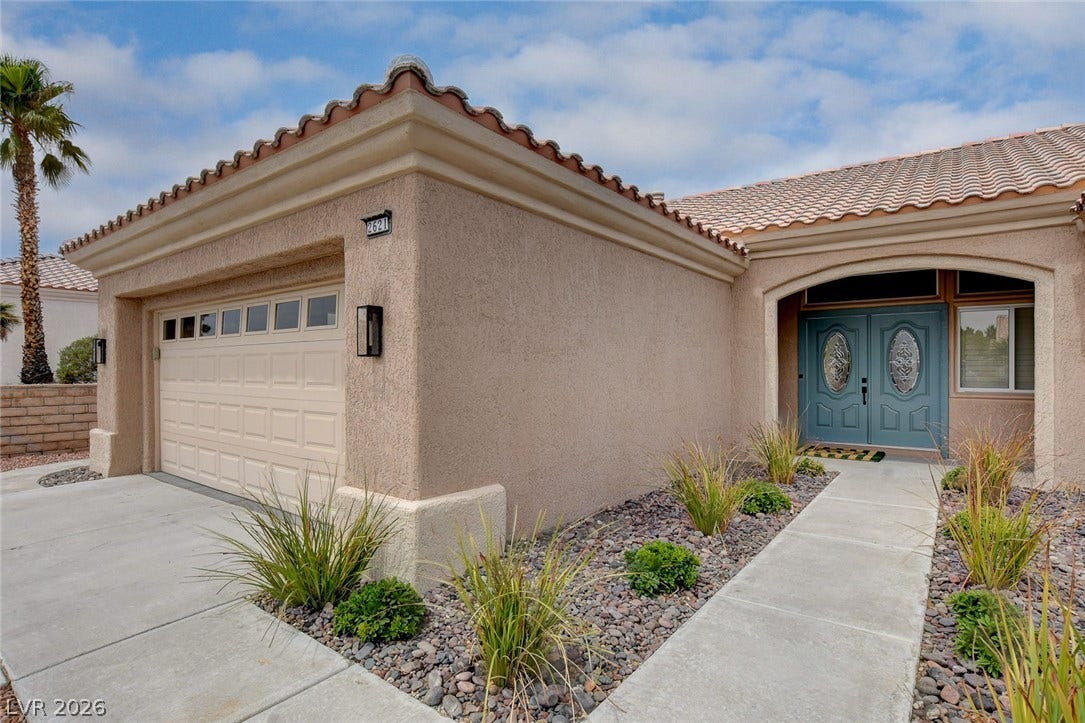 2621 Hanging Rock Drive, Las Vegas, NV 89134 Spanish tile roofing and classic stucco finish enhance this welcoming single-level entryway.