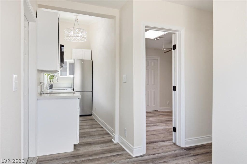 3912 Casa Grande Avenue, Las Vegas, NV 89102 Smooth wood-look flooring guides the eye through this bright, modern hallway transition.