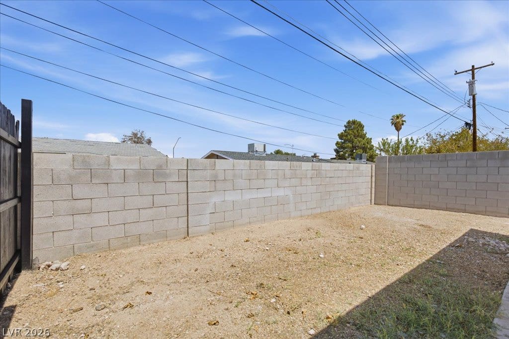 3912 Casa Grande Avenue, Las Vegas, NV 89102 Solid block walls secure the backyard perimeter under clear desert skies.