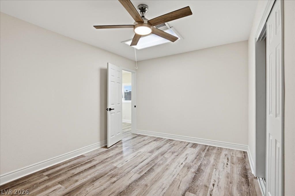 3912 Casa Grande Avenue, Las Vegas, NV 89102 Smooth wood-style flooring runs beneath neutral walls and a recessed ceiling access point.
