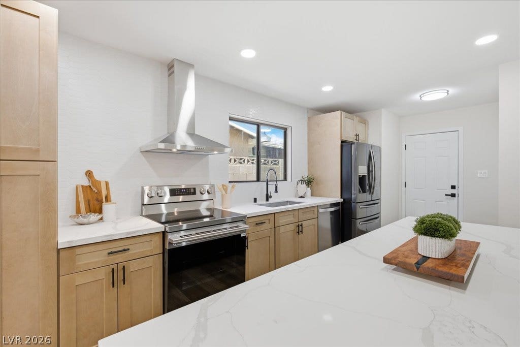 3912 Casa Grande Avenue, Las Vegas, NV 89102 Streamlined cabinetry and expansive stone countertops define this modern, functional workspace.