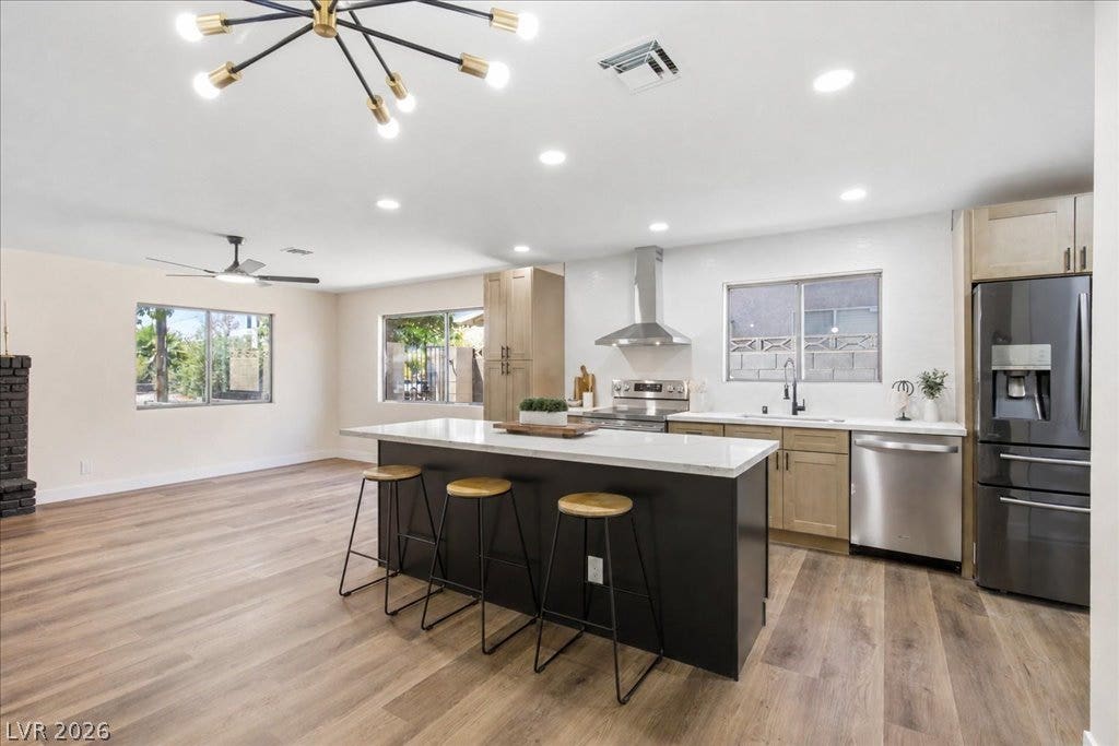 3912 Casa Grande Avenue, Las Vegas, NV 89102 An open kitchen seamlessly connects with the adjacent living space over durable wood-look flooring.