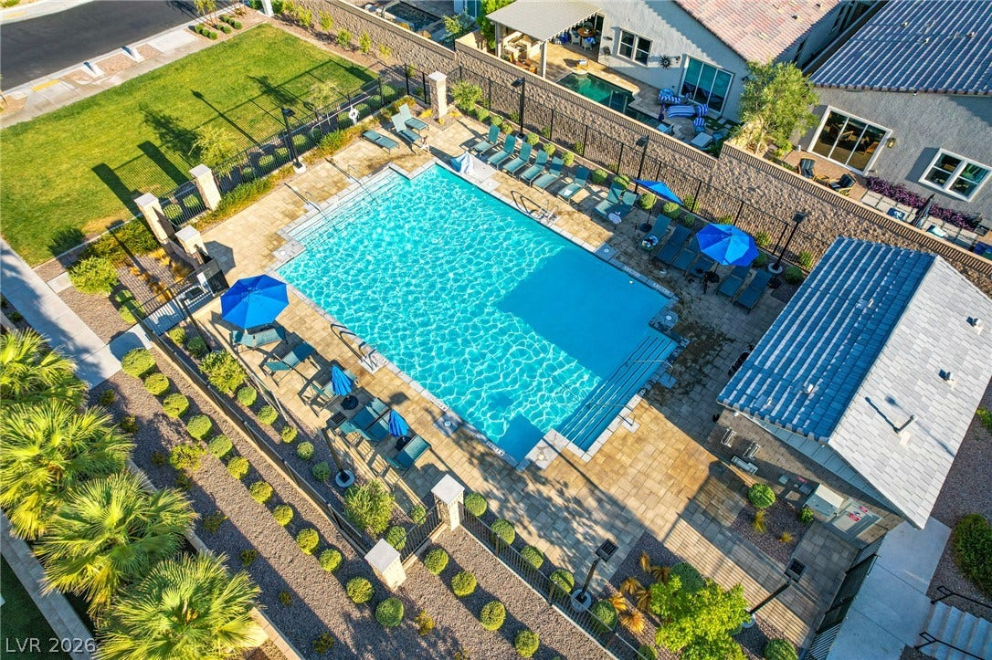 10226 Pleasant Knoll Avenue, Las Vegas, NV 89166 An inviting community swimming pool features a paved sun deck and a shaded cabana structure.
