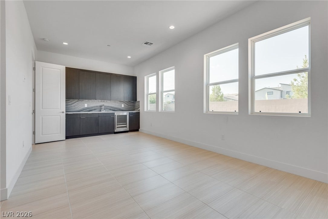10226 Pleasant Knoll Avenue, Las Vegas, NV 89166 Downstairs flex suite: can be used for variety of purpose. It comes with sink, wine fridge, cabinetry & beautiful counter tops.