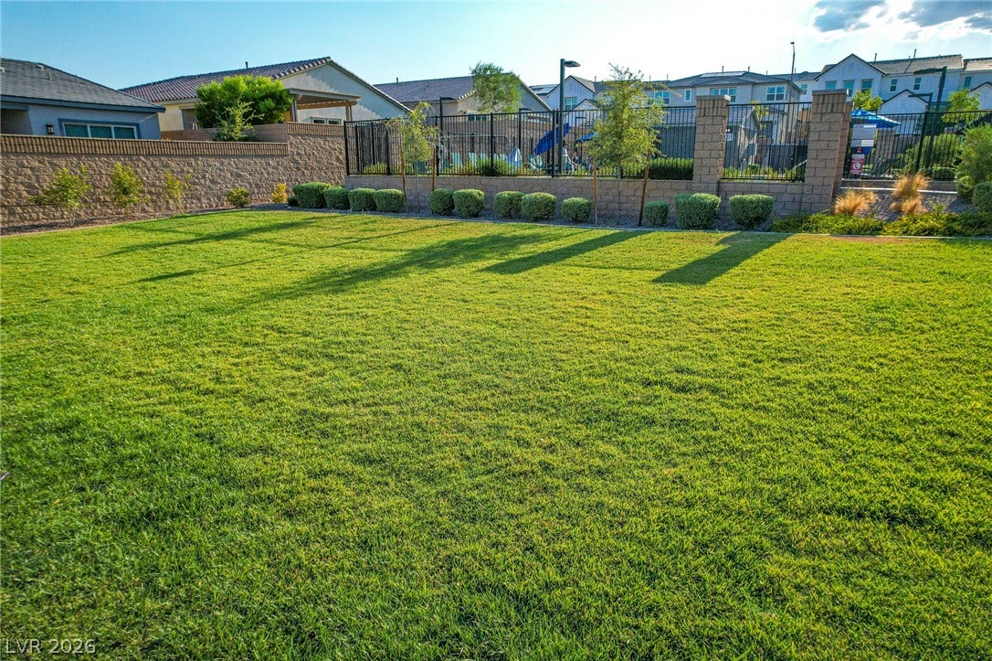 10226 Pleasant Knoll Avenue, Las Vegas, NV 89166 A spacious lawn provides ample outdoor space next to the community pool.