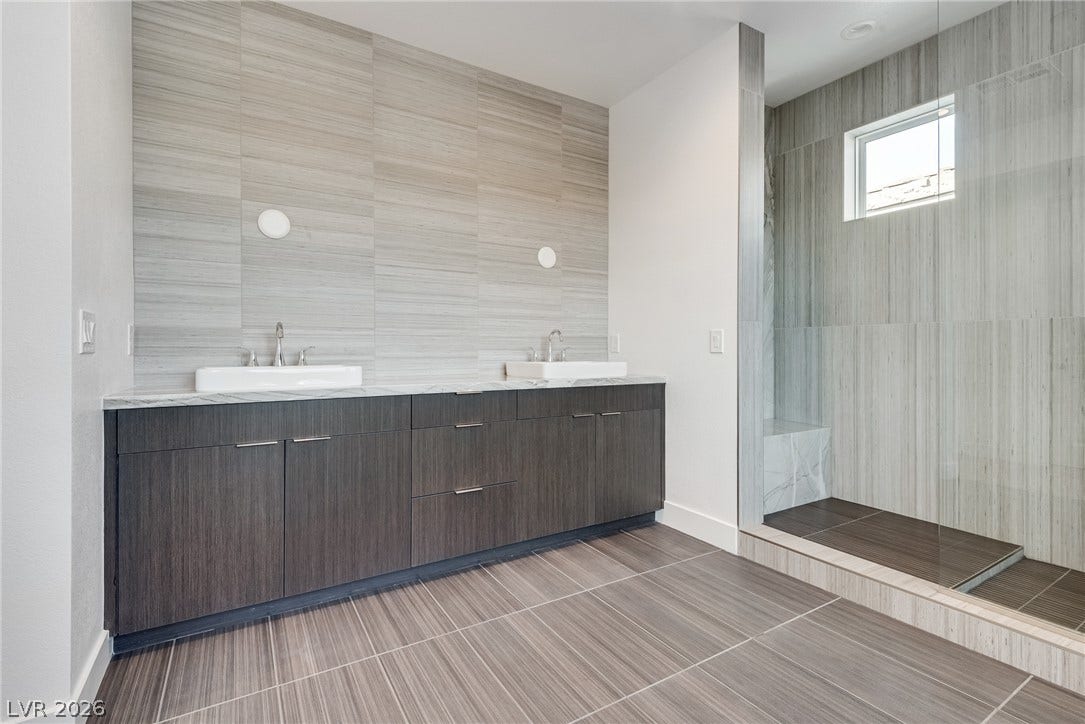10226 Pleasant Knoll Avenue, Las Vegas, NV 89166 Spa-like primary bathroom with dual vanity and a spacious walk-in shower.