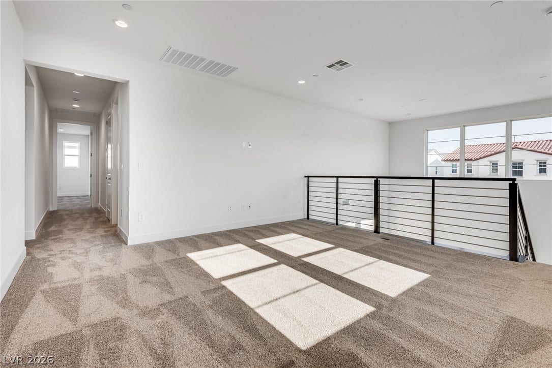 10226 Pleasant Knoll Avenue, Las Vegas, NV 89166 Plush carpeting and modern metal railings define this versatile upper-level loft area.